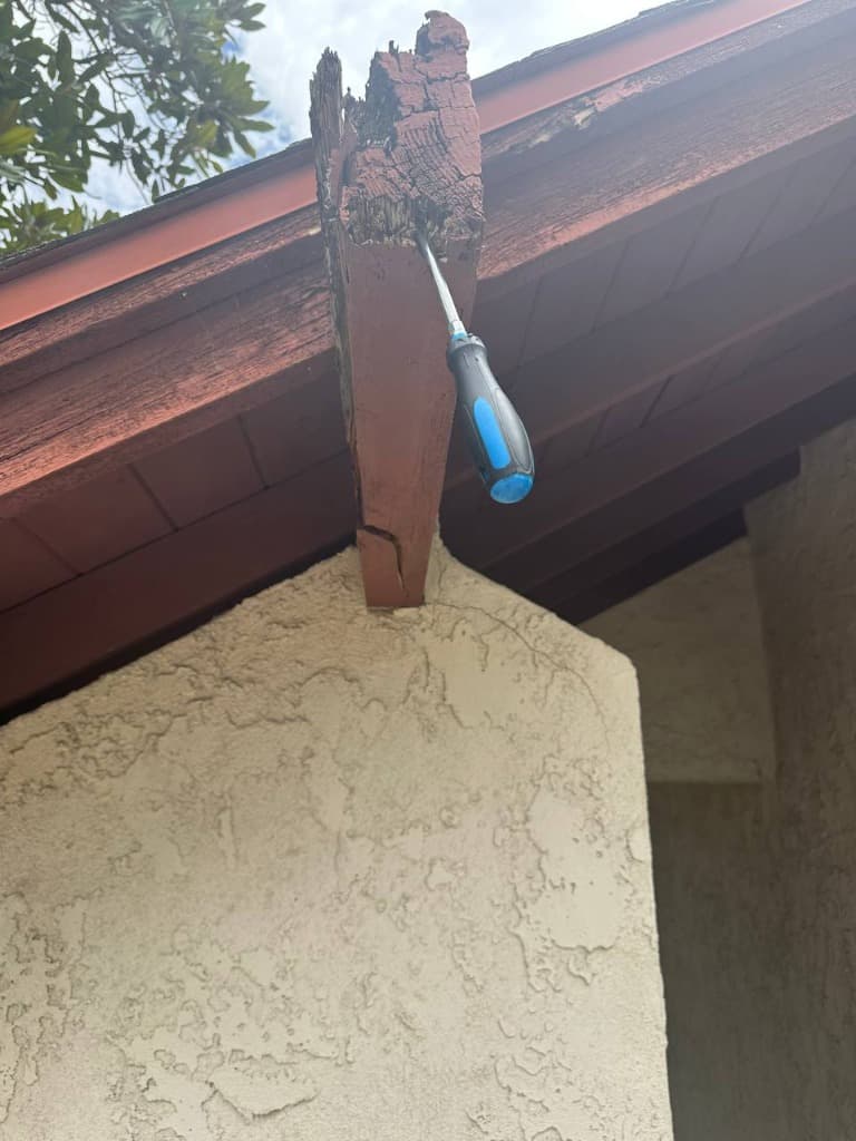 Completely hollowed out cantilever outrigger beam supporting balcony corner